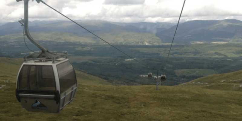 Photo of the Nevis Range Gondola in operation with mountains visible in the distance.